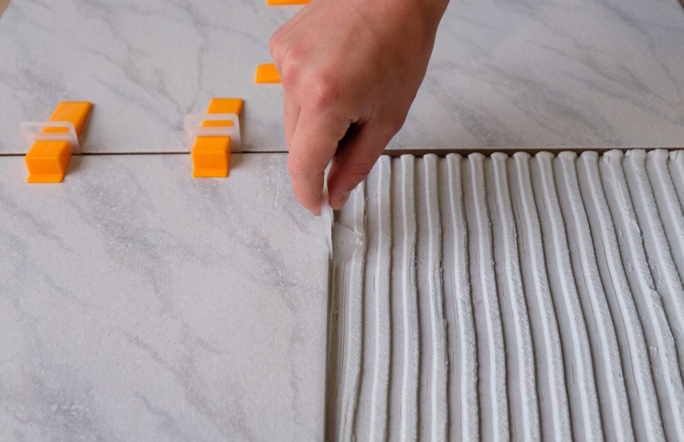 Step 1: slide the clips under the tiles