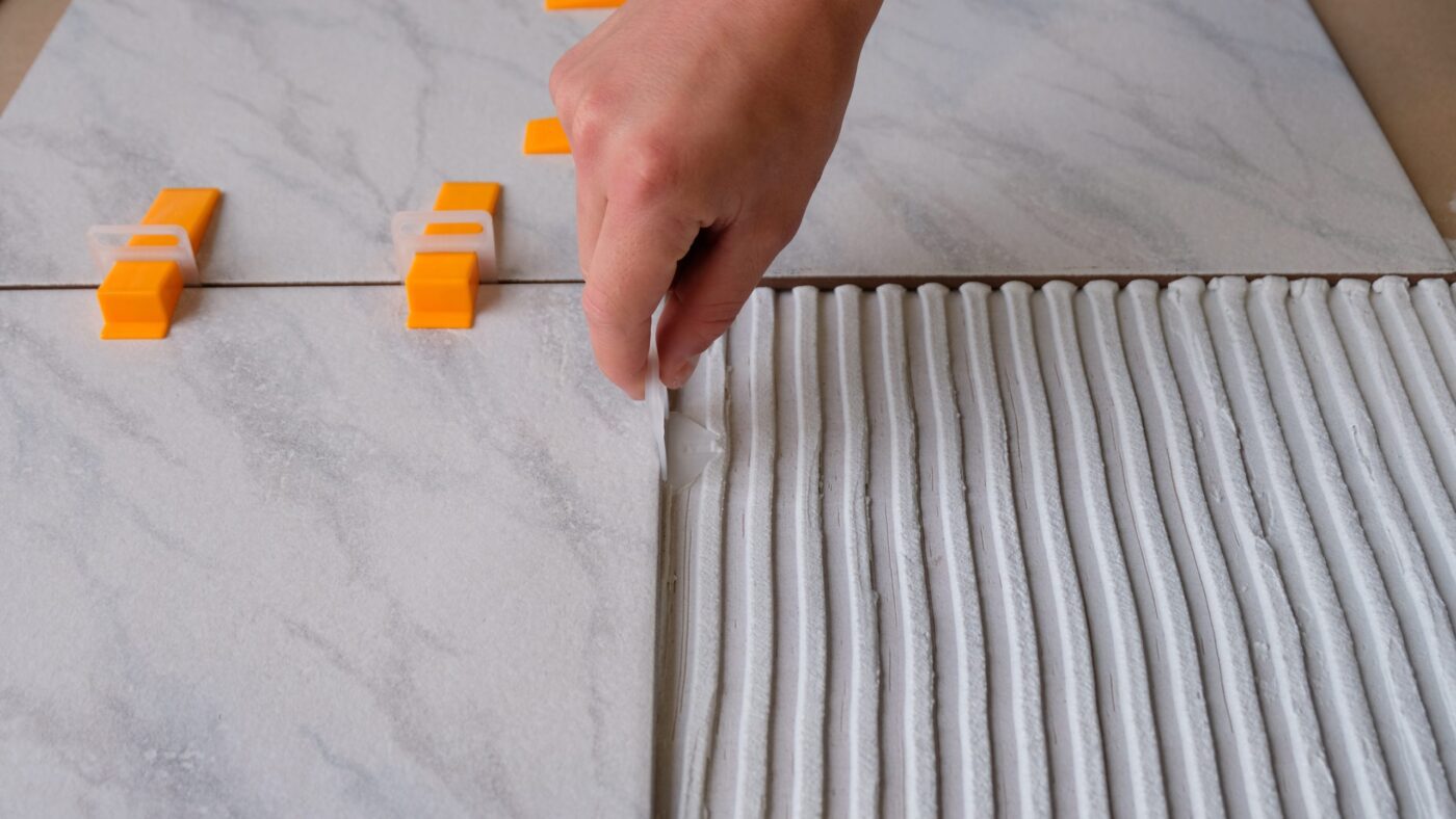 Step 1: slide the clips under the tiles
